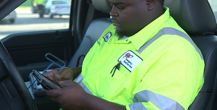 AAA road technician fills out form on tablet