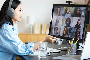 Employee at desk attending online meeting