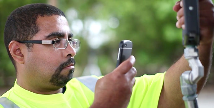 Tanknology staff using smartphone to inspect equipment
