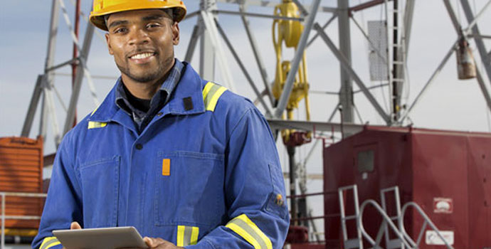 Technician holding tablet in oil extraction site