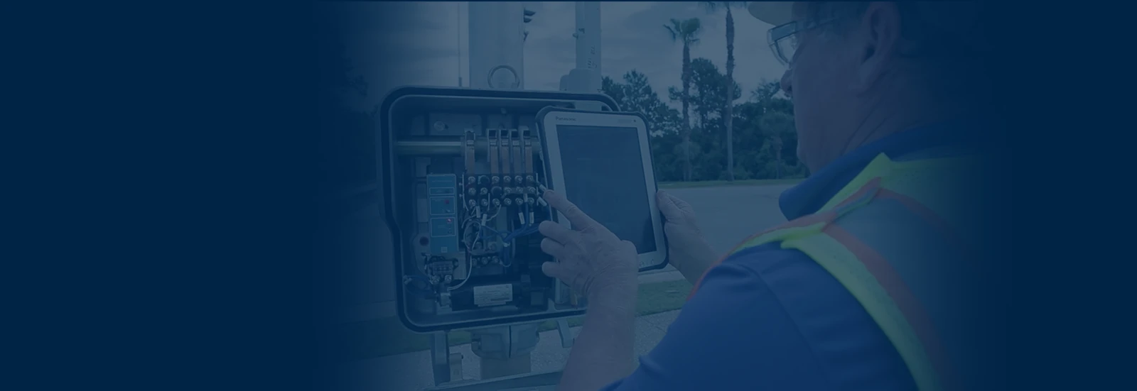 Utility technician taking photo with tablet device