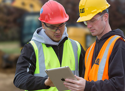 Louisiana CAT field engineers looking at tablet in construction site