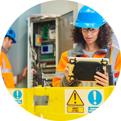 Elevator technician looking at tablet device