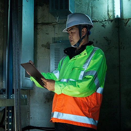 Elevator technician holding tablet