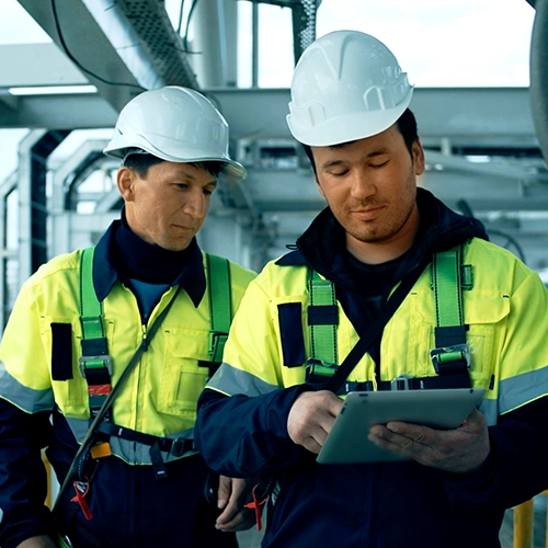 Oil & gas technicians looking at tablet