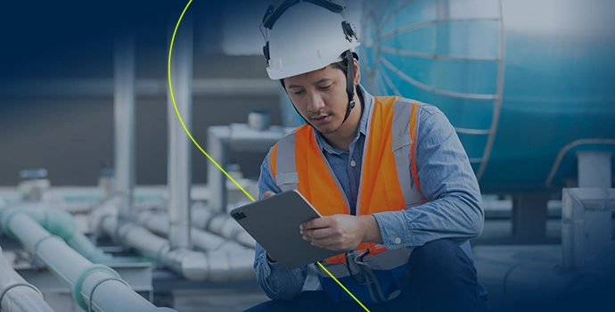 Technician inspecting tank with tablet